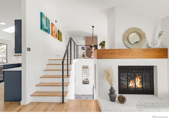 3809 Howe Ct, Boulder, CO 80301 - stairs featuring recessed lighting, baseboards, wood finished floors, and a fireplace