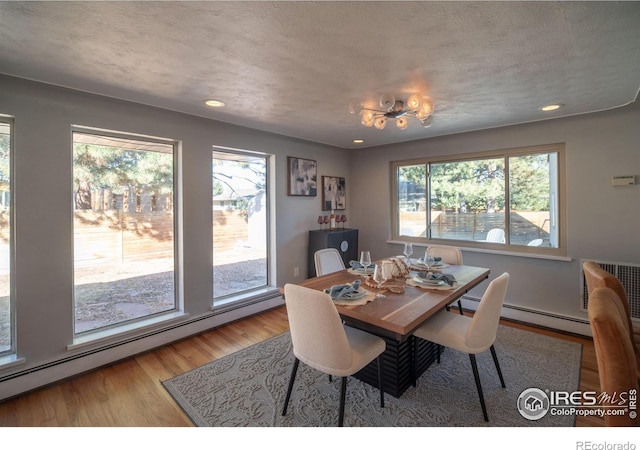 2605 Crabapple Ct, Golden, CO 80401 - dining area with plenty of natural light, recessed lighting, light wood-style flooring, and a baseboard heating unit
