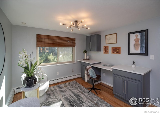 2605 Crabapple Ct, Golden, CO 80401 - office featuring a notable chandelier, a baseboard heating unit, baseboards, and light wood finished floors