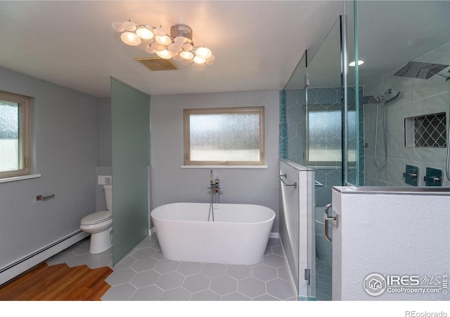 2605 Crabapple Ct, Golden, CO 80401 - bathroom featuring visible vents, a tile shower, a wealth of natural light, and a baseboard radiator