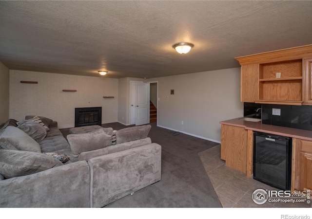 2605 Crabapple Ct, Golden, CO 80401 - carpeted living room with a textured ceiling, stairs, wine cooler, and a glass covered fireplace