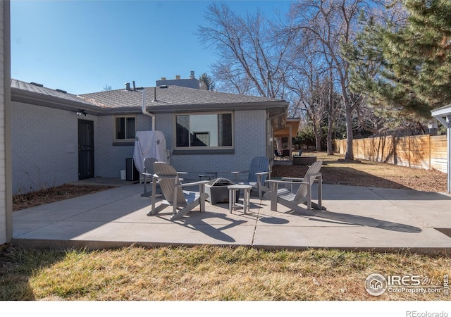 2605 Crabapple Ct, Golden, CO 80401 - rear view of house with fence, a fire pit, a patio area, and brick siding