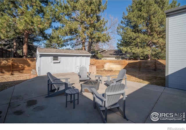 2605 Crabapple Ct, Golden, CO 80401 - view of patio / terrace featuring a storage shed, an outbuilding, a fenced backyard, and an outdoor fire pit