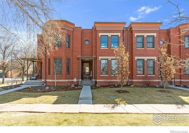 2890 Curtis St, Denver, CO 80205 - view of property featuring brick siding and a front lawn