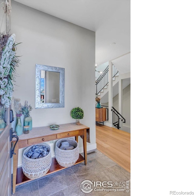 2890 Curtis St, Denver, CO 80205 - entryway featuring stairway, wood finished floors, and baseboards