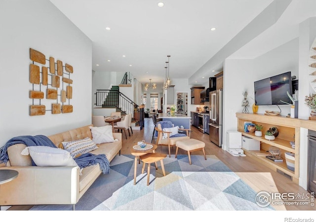 2890 Curtis St, Denver, CO 80205 - living area featuring stairway, light wood-style floors, a chandelier, and recessed lighting