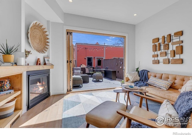 2890 Curtis St, Denver, CO 80205 - living area with wood finished floors, a glass covered fireplace, and recessed lighting
