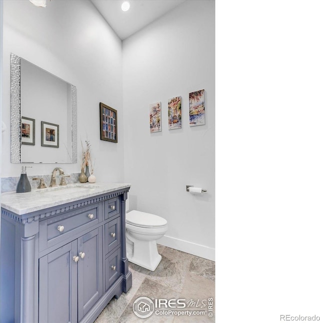 2890 Curtis St, Denver, CO 80205 - bathroom with baseboards, toilet, and vanity