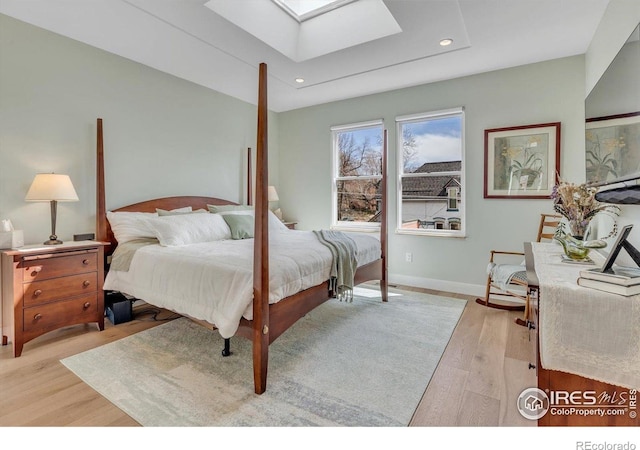 2890 Curtis St, Denver, CO 80205 - bedroom featuring a skylight, light wood-type flooring, recessed lighting, and baseboards