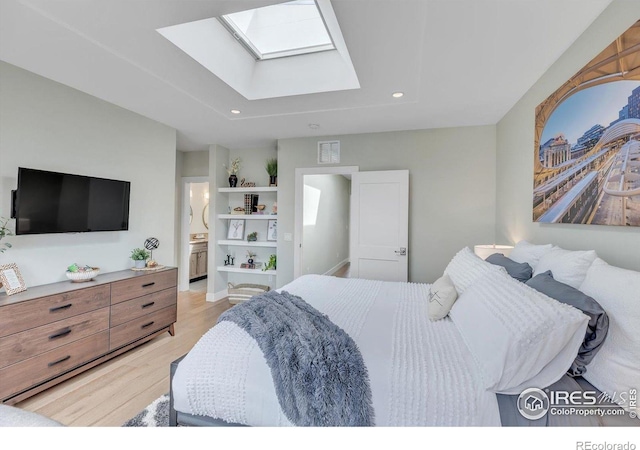 2890 Curtis St, Denver, CO 80205 - bedroom with a skylight, light wood-style floors, recessed lighting, and connected bathroom