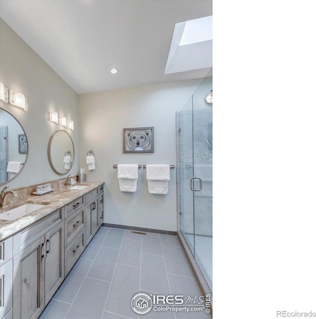 2890 Curtis St, Denver, CO 80205 - full bath featuring baseboards, a stall shower, tile patterned floors, double vanity, and a skylight