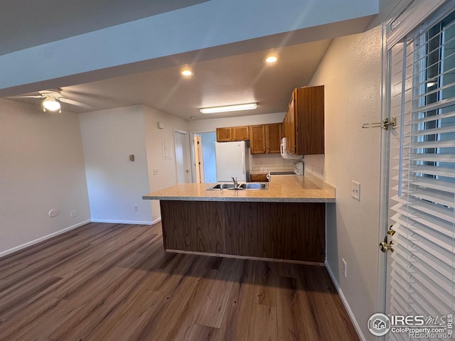 3565 Windmill Dr Unit 3, Fort Collins, CO 80526 - kitchen featuring dark wood-style flooring, freestanding refrigerator, brown cabinets, a peninsula, and recessed lighting