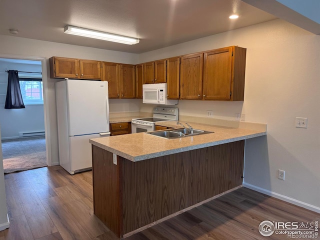 3565 Windmill Dr Unit 3, Fort Collins, CO 80526 - kitchen with white appliances, a sink, a peninsula, light countertops, and a baseboard heating unit