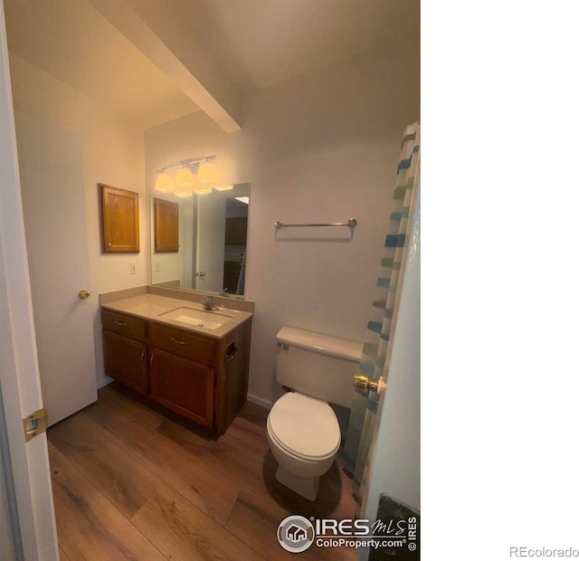 3565 Windmill Dr Unit 3, Fort Collins, CO 80526 - bathroom featuring wood finished floors, toilet, vanity, and beam ceiling