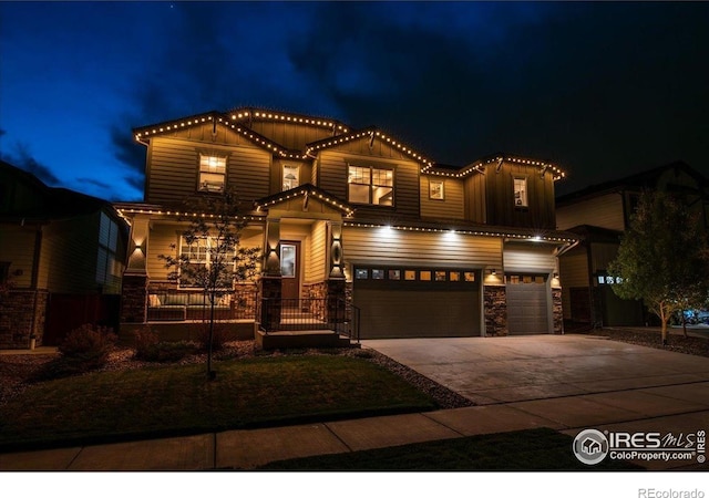 view of front of home with a garage, board and batten siding, driveway, and stone siding