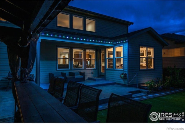 rear view of property featuring an outdoor hangout area