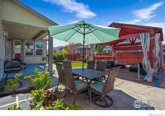 view of patio featuring fence, outdoor dining area, and outdoor lounge area