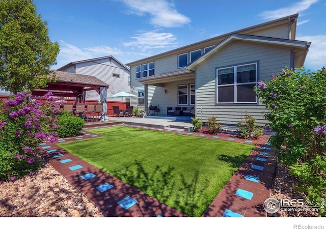 back of house with a lawn, a gazebo, and a patio area