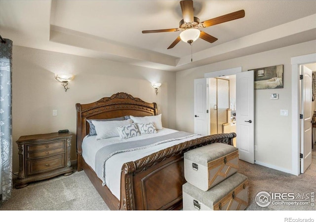bedroom with carpet floors, a raised ceiling, ceiling fan, and baseboards
