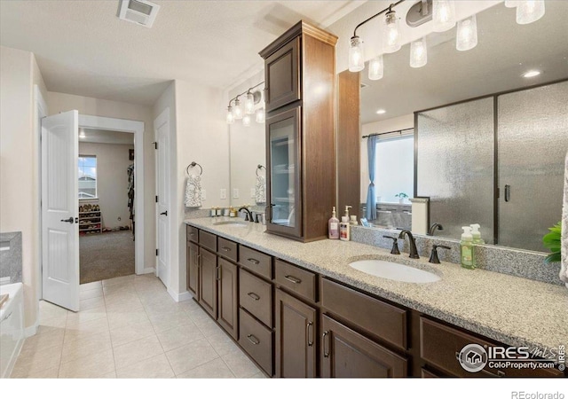full bath with visible vents, a sink, tile patterned flooring, and double vanity