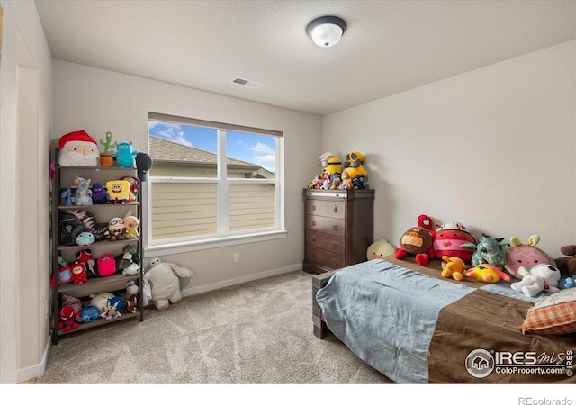 carpeted bedroom featuring baseboards and visible vents