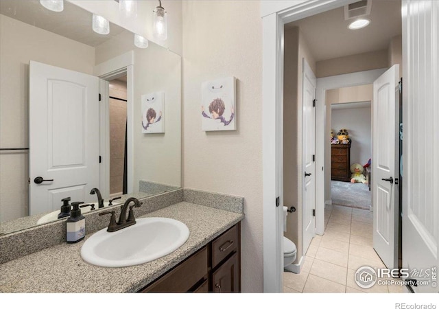 bathroom featuring toilet, tile patterned floors, visible vents, and vanity