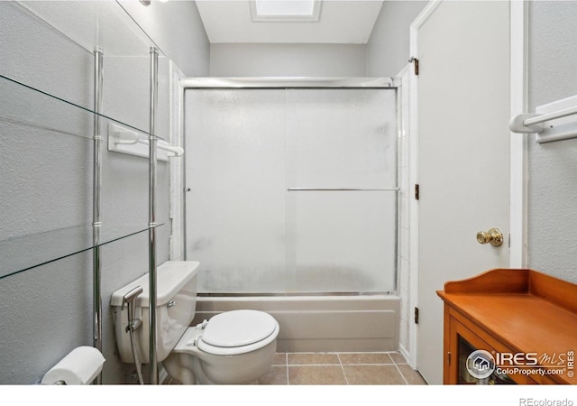 13755 W 65th Dr, Arvada, CO 80004 - full bathroom featuring toilet, tile patterned flooring, and combined bath / shower with glass door