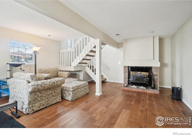 13755 W 65th Dr, Arvada, CO 80004 - living area with stairway, wood finished floors, a textured ceiling, and baseboards