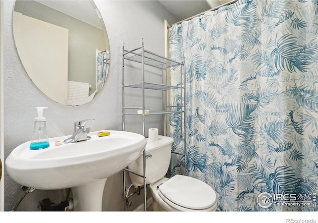 13755 W 65th Dr, Arvada, CO 80004 - bathroom with toilet, a shower with curtain, and a sink