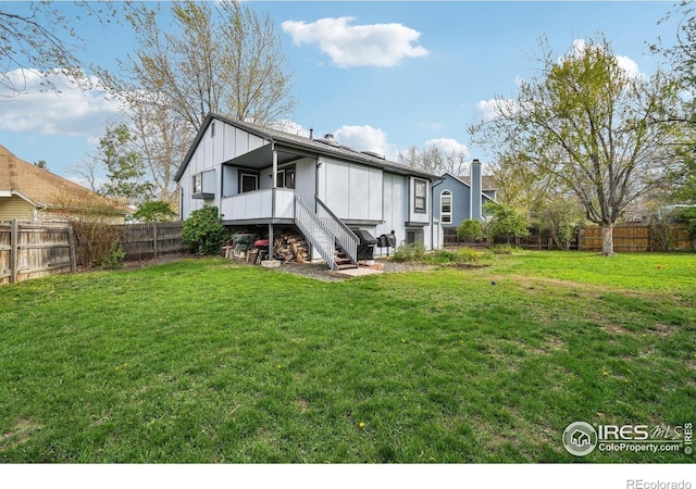 13755 W 65th Dr, Arvada, CO 80004 - back of property featuring stairway and board and batten siding