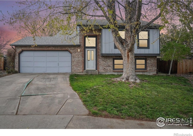 13755 W 65th Dr, Arvada, CO 80004 - bi-level home with driveway, brick siding, an attached garage, board and batten siding, and a shingled roof