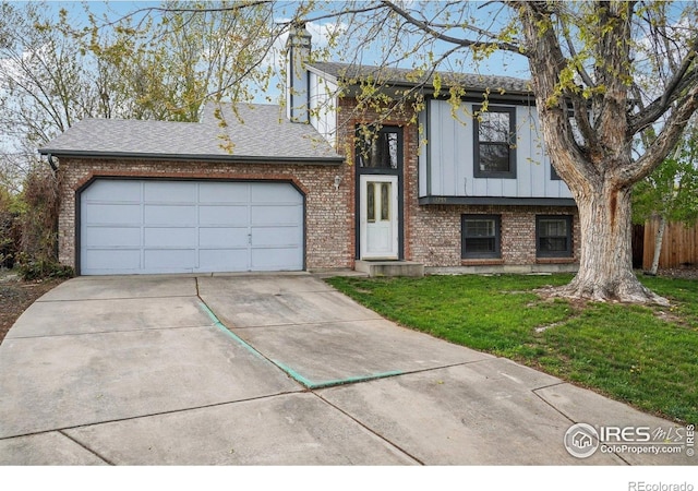13755 W 65th Dr, Arvada, CO 80004 - view of front of property with board and batten siding, concrete driveway, brick siding, and a garage