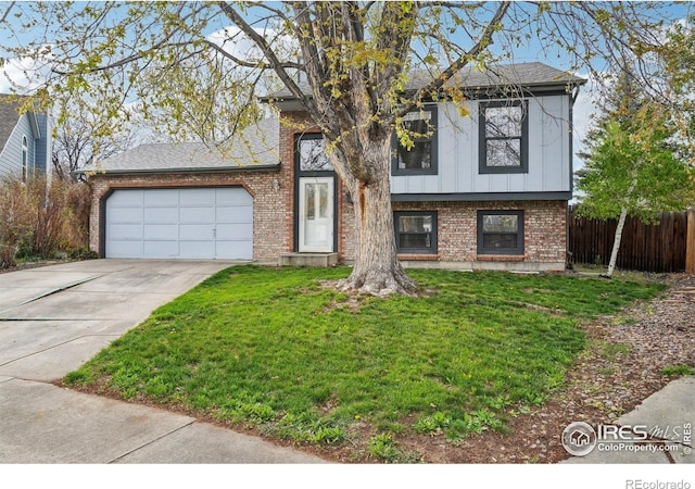 13755 W 65th Dr, Arvada, CO 80004 - view of front of home featuring an attached garage, concrete driveway, brick siding, and board and batten siding