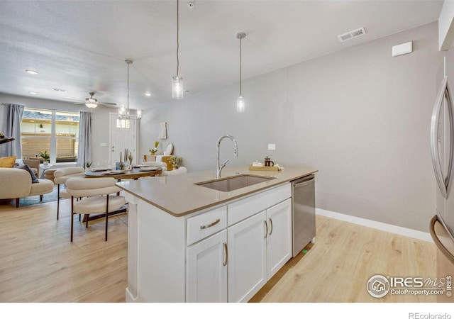968 Birdwhistle Ln Unit 6, Fort Collins, CO 80524 - kitchen featuring a sink, stainless steel appliances, light wood-style flooring, open floor plan, and ceiling fan