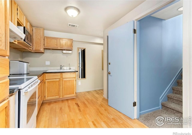 511 Spindrift Ct, Fort Collins, CO 80525 - kitchen with visible vents, white electric range, baseboards, light wood-style floors, and under cabinet range hood