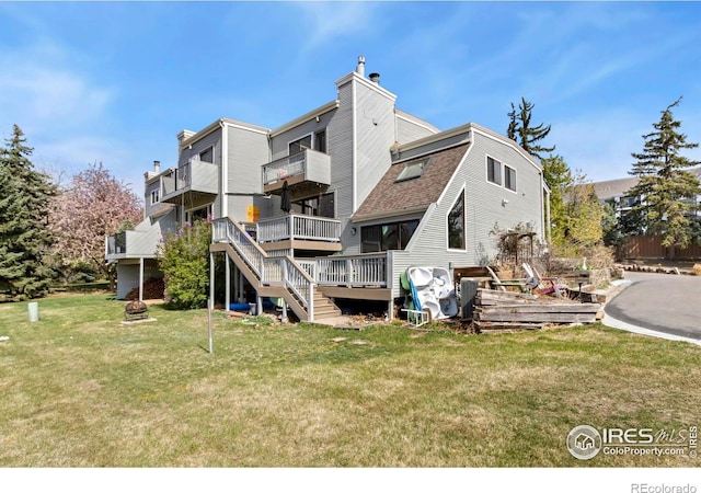 511 Spindrift Ct, Fort Collins, CO 80525 - back of property featuring a chimney, stairway, a balcony, a yard, and a shingled roof