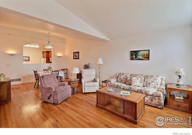 355 47th Ave Unit A, Greeley, CO 80634 - living room with visible vents, light wood finished floors, and lofted ceiling