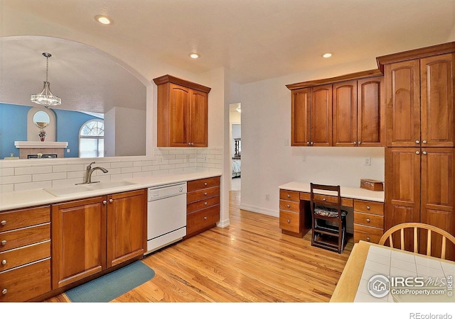 355 47th Ave Unit A, Greeley, CO 80634 - kitchen with white dishwasher, brown cabinetry, and light wood-style floors