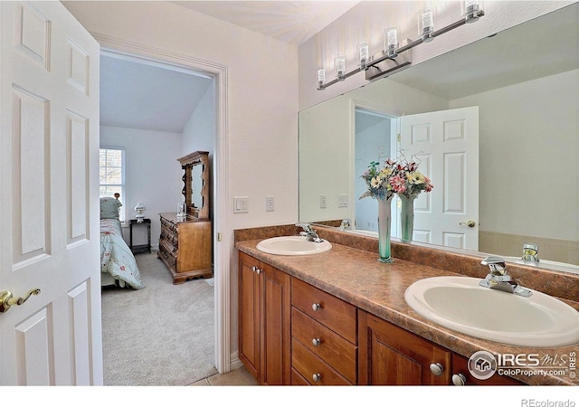 355 47th Ave Unit A, Greeley, CO 80634 - ensuite bathroom featuring double vanity, a sink, and ensuite bathroom