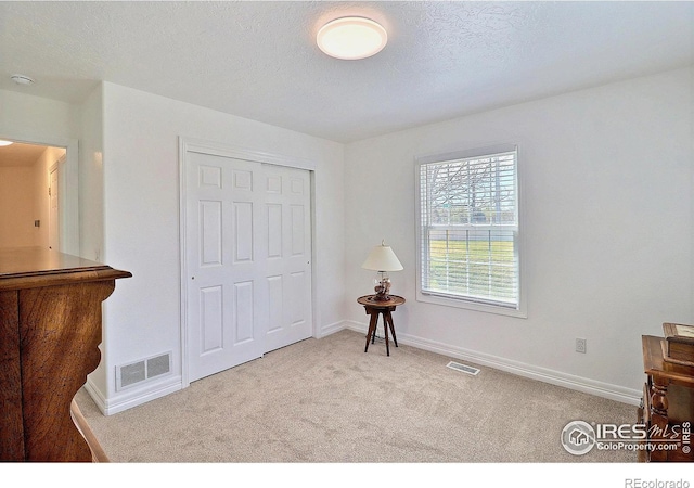 355 47th Ave Unit A, Greeley, CO 80634 - bedroom featuring carpet floors, baseboards, a closet, and visible vents