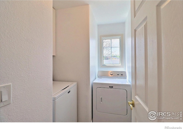 355 47th Ave Unit A, Greeley, CO 80634 - washroom with laundry area, a textured wall, and washing machine and clothes dryer