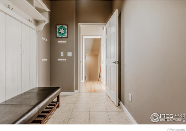 mudroom featuring baseboards and light tile patterned floors