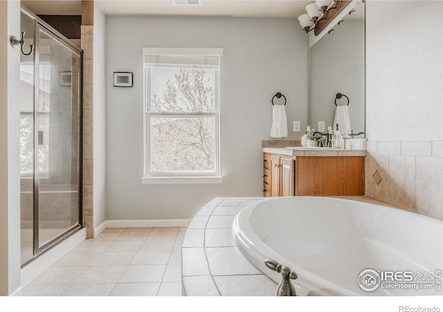bathroom with vanity, baseboards, a bath, tile patterned floors, and a shower stall