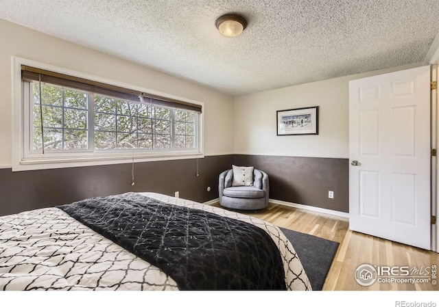 1352 S Terry St, Longmont, CO 80501 - bedroom with a textured ceiling, baseboards, and wood finished floors