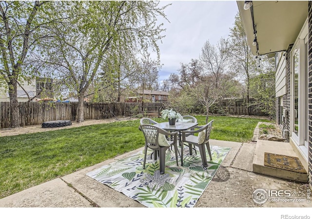 1352 S Terry St, Longmont, CO 80501 - view of patio featuring a fenced backyard and outdoor dining space