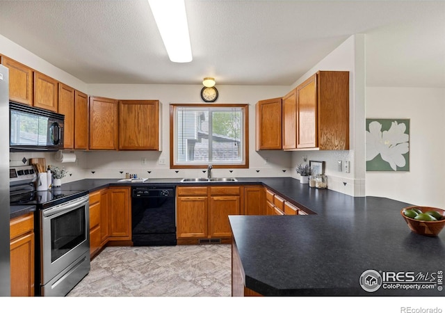 2476 Forsythia Dr, Loveland, CO 80537 - kitchen with a sink, dark countertops, black appliances, and brown cabinets