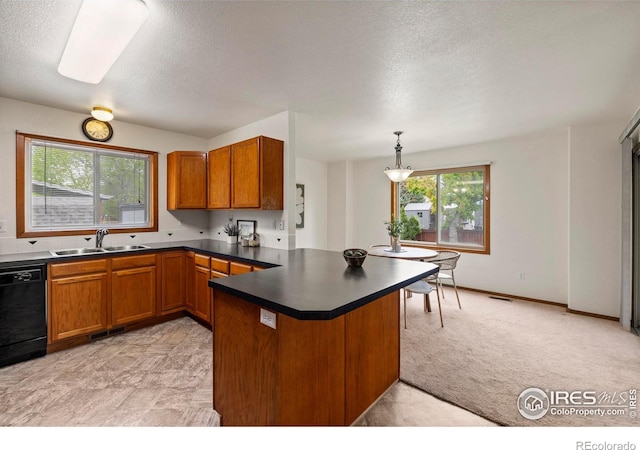 2476 Forsythia Dr, Loveland, CO 80537 - kitchen with brown cabinetry, a sink, a peninsula, and dishwasher