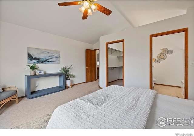 2476 Forsythia Dr, Loveland, CO 80537 - carpeted bedroom with baseboards, vaulted ceiling, ceiling fan, and a spacious closet