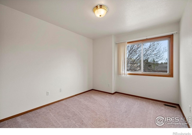 2476 Forsythia Dr, Loveland, CO 80537 - unfurnished room featuring carpet floors, baseboards, and visible vents