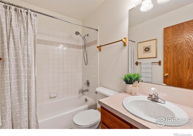2476 Forsythia Dr, Loveland, CO 80537 - bathroom with vanity, a textured wall, shower / bath combo, and toilet